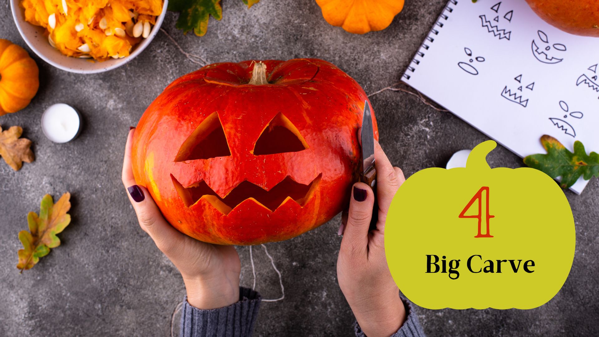 Step 4 on pumpkin carving is Big Carve. Shows photo of hands holding a carved jack o lantern with a knife in hand overlooking a festive Halloween table